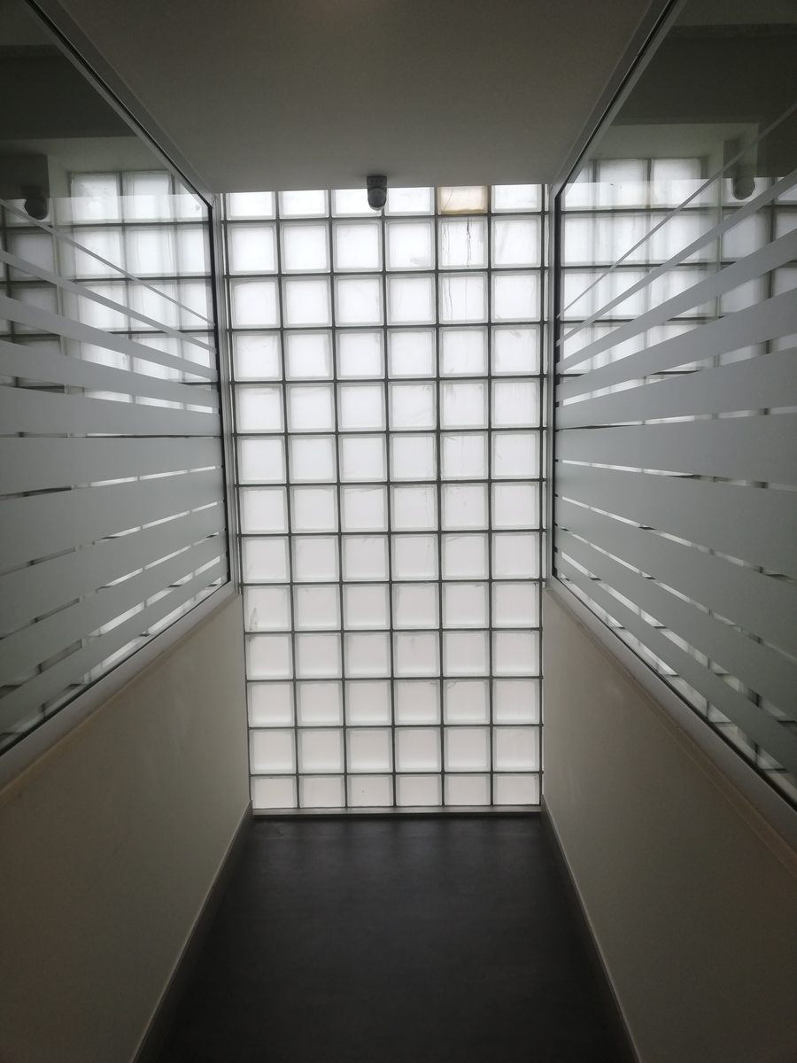 Glass-block wall at the end of the corridor